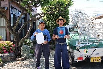 写真：表示証を持つ大塚さん