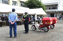 写真：収集した災害情報報告書を提出している座間郵便局の集配用バイク隊