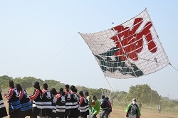 写真：「新風」と書かれた大凧が空に揚がる様子