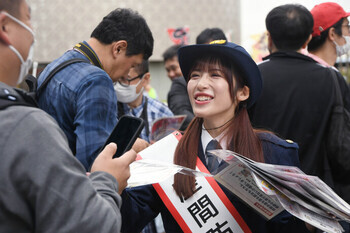 写真:啓発用のチラシを配るやまざきはるなさん